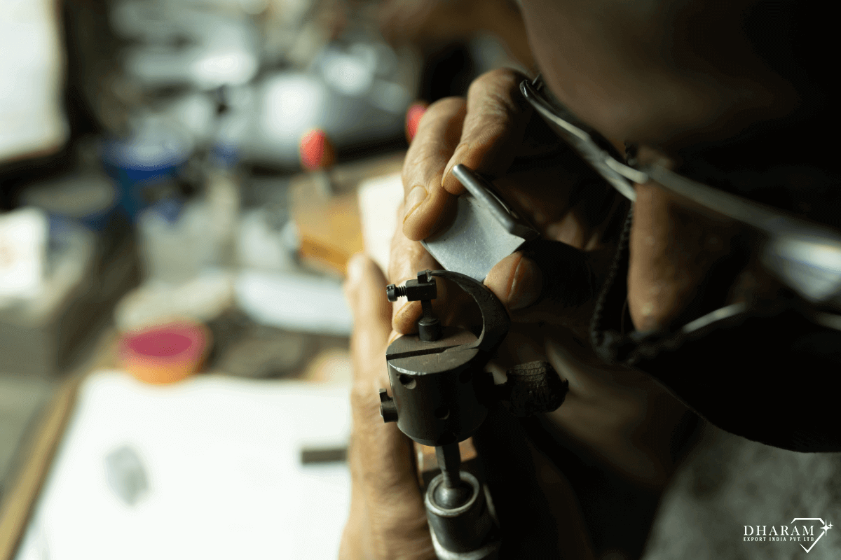 A Diamond polisher seen examining the stone while polishing